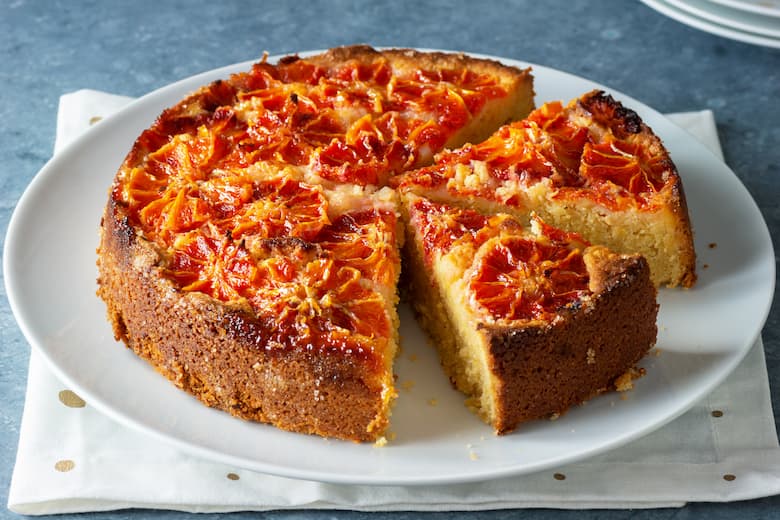 blood orange almond citrus cake with slices cut on a plate